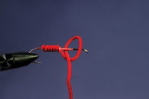 tying red half hitch on hook